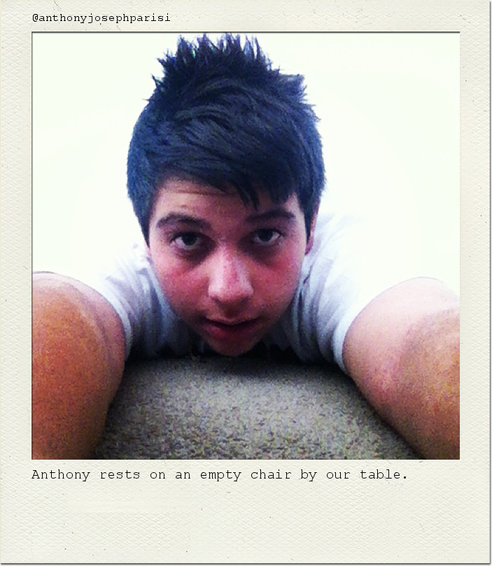 Anthony rests on an empty chair by our table.