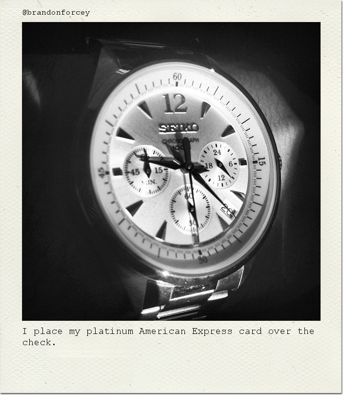 I place my platinum American Express card over the check.
