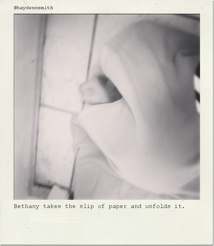 Bethany takes the slip of paper and unfolds it.