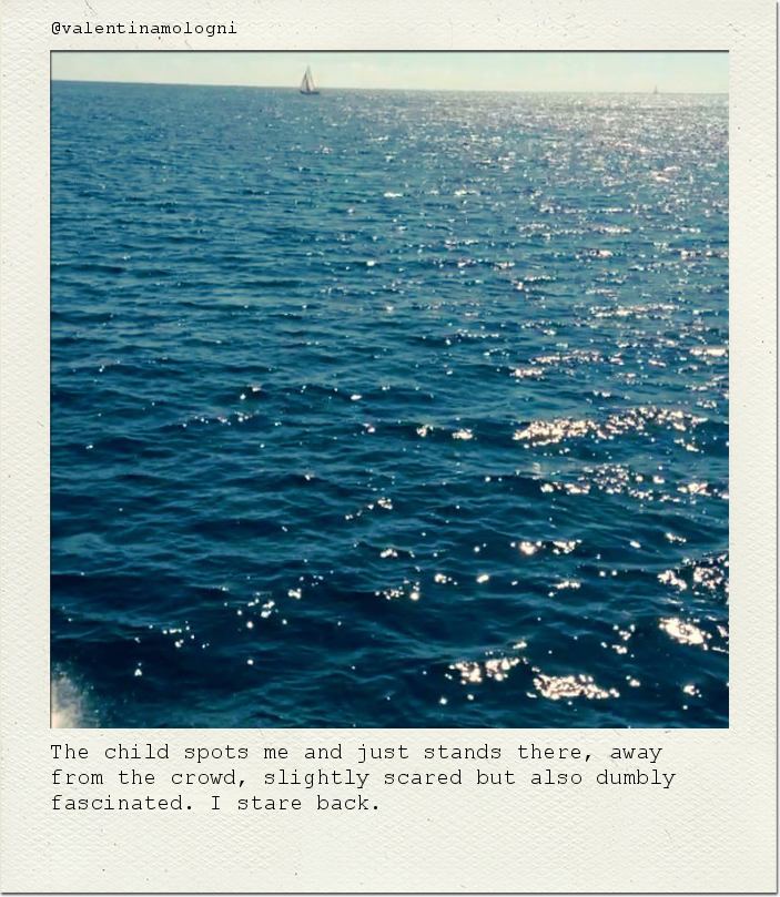 The child spots me and just stands there, away from the crowd, slightly scared but also dumbly fascinated. I stare back.