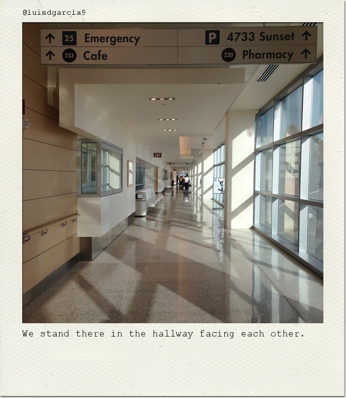 We stand there in the hallway facing each other.