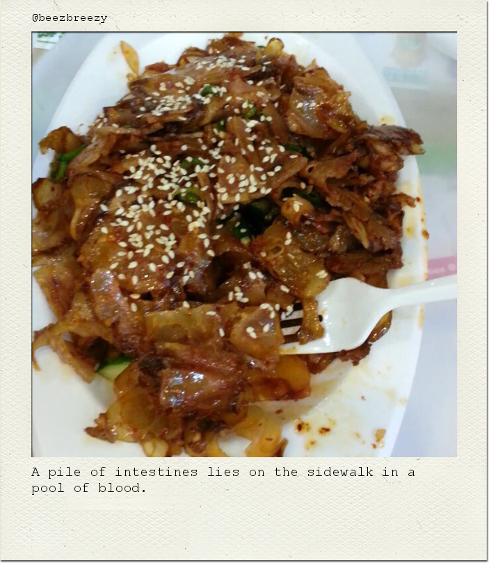 A pile of intestines lies on the sidewalk in a pool of blood.