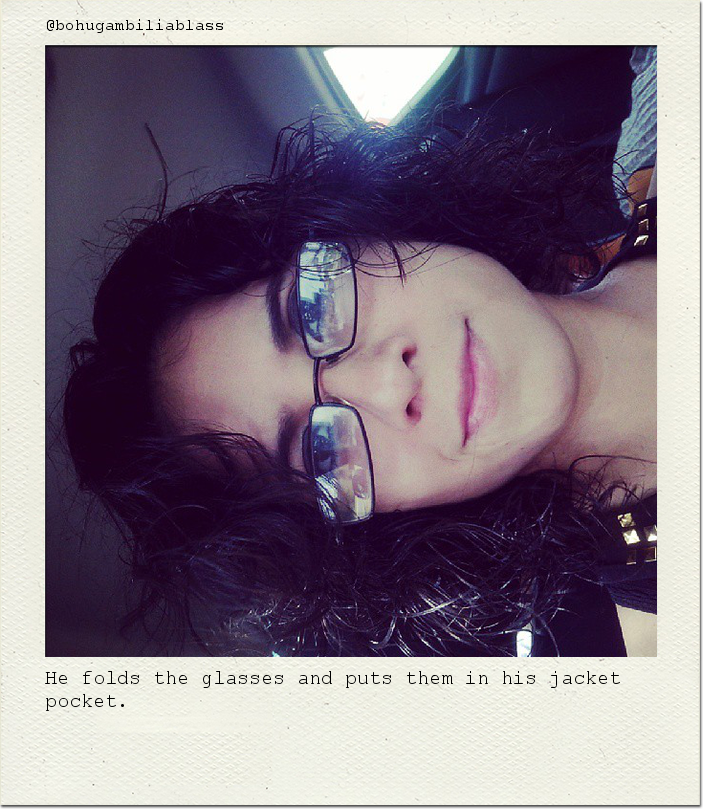 He folds the glasses and puts them in his jacket pocket.